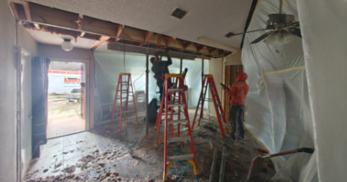 Wall removal safety assessment underway in Plano TX home with crew and ladders